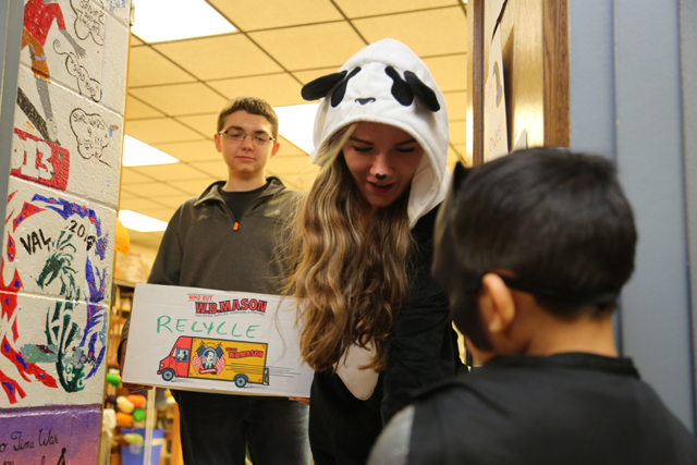 Riverhead High School sophomores Ciara Tobin and Noah Brandi hand out candy to trick-or-treaters at the Key Club's Safe Halloween event.