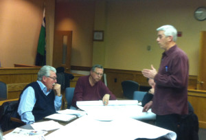 TIM GANNON PHOTO | Salon owner Ray Pickersgill (left) hears a pitch for a barbecue contest and music festival from John Barci at Wednesday night's BID management association meeting.