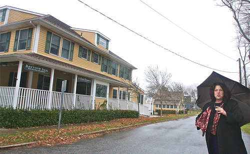 Angela DeVito, president of the South Jamesport Civic Association, outside the Bayview Inn & Restaurant. The group has yet to take an official on a plan to convert the building to apartments, and split the parcel into two separate lots. (Credit: Barbaraellen Koch)