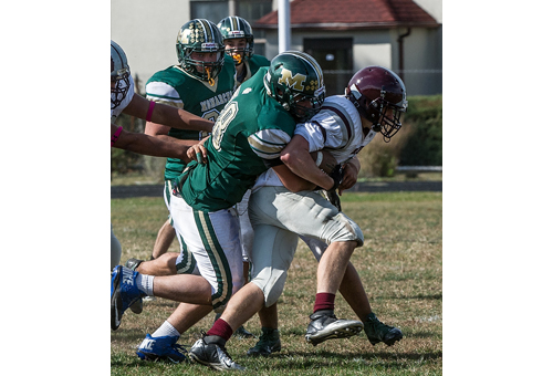 ROBERT O'ROURK PHOTO | Bishop McGann-Mercy's Kenny Berman bringing down an East Hampton/Bridgehampton ball carrier.