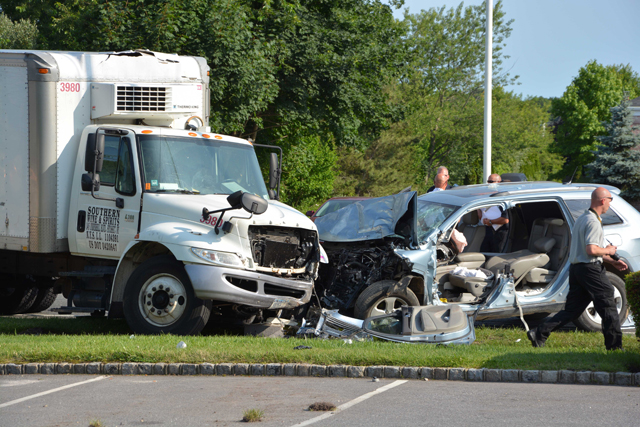 Police investigate the scene of the crash. (Credit: AJ Ryan, Stringer News Service)