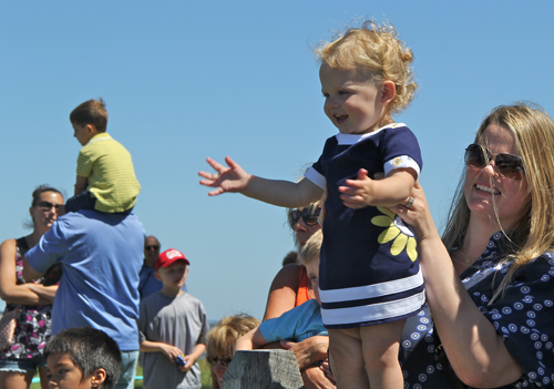 CARRIE MILLER PHOTO | 18-month-old Julianna Elefonte cheers on as the ducks near the finish line.