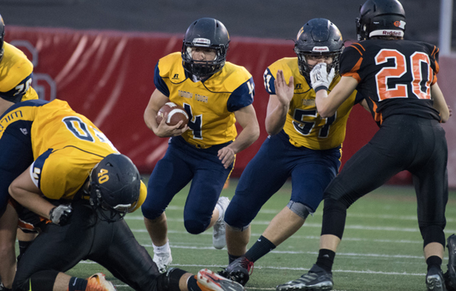 Chris Gray carries the ball for Shoreham-Wading River Saturday. (Credit: Robert O'Rourk)