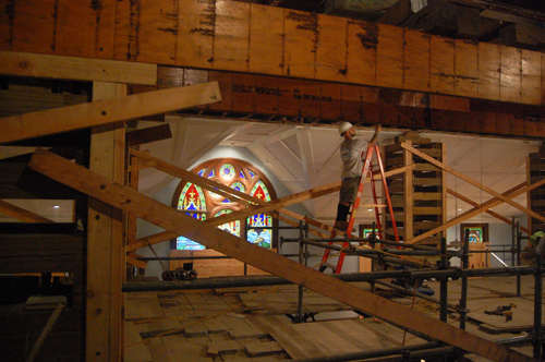 A construction worker earlier this week on a temporary second floor held up with scaffolding. (Credit: Nicole Smith)
