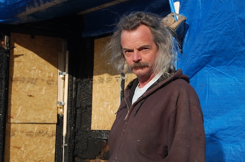 Homeowner A.J. Travis outside the home Monday morning. (Credit: Cyndi Murray)