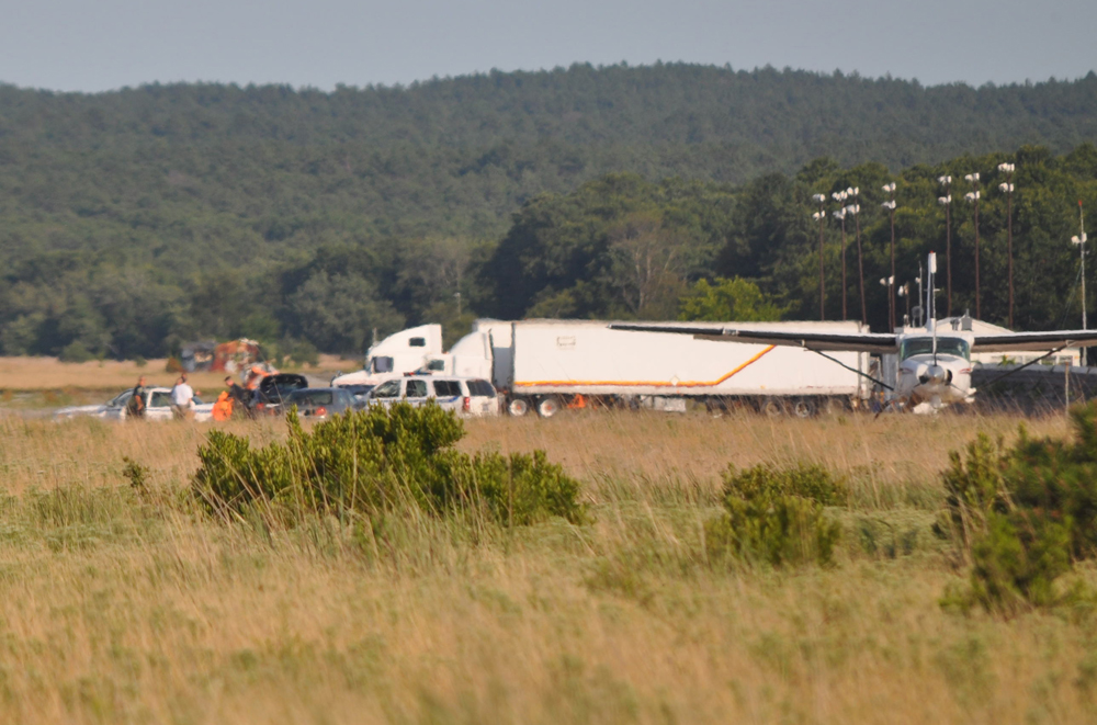 Investigators on the scene of the crash. (Credit: Grant Parpan)