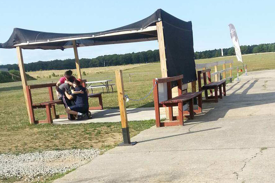 A man hugs a child at the scene of Wednesday's fatal skydiving accident. (Credit: Jennifer Gustavson)