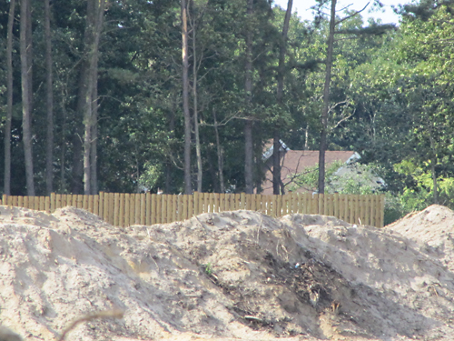 TIM GANNON PHOTO | At the site of the Costco development, trees were cleared up to the property line of Foxwood Village.