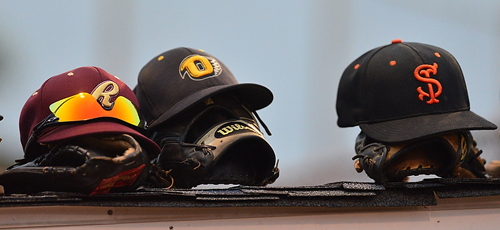 ROBERT O'ROURK PHOTO | The caps of the Riverhead Tomcats, the North Fork Ospreys and the Shelter Island Bucks on top of the North All Stars dugout. For one game, representatives of those teams were teammates.