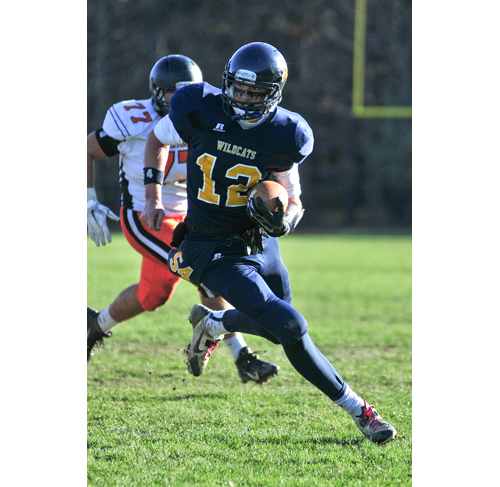 Shoreham-Wading River quarterback Danny Hughes carries the ball in Saturday's win over Babylon. (Credit: Bill Landon)