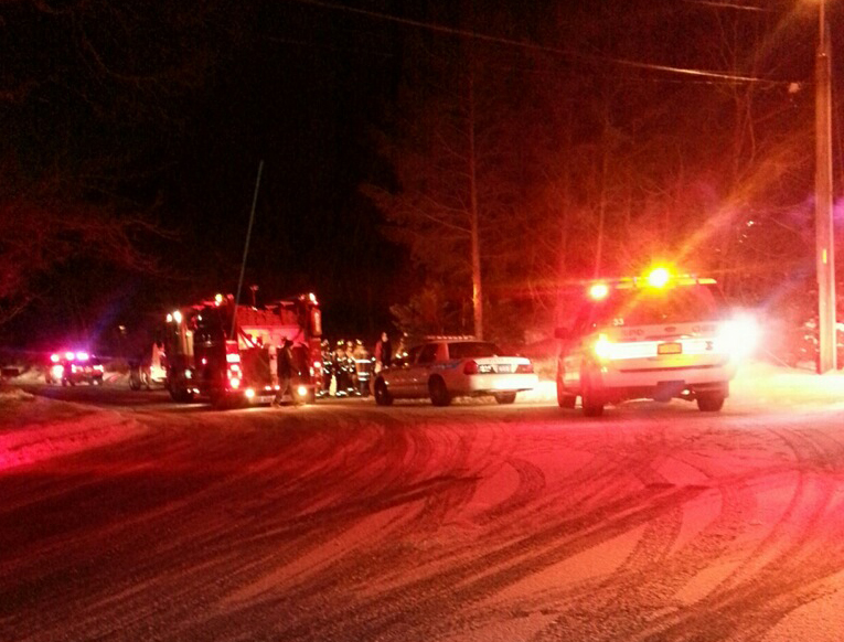 Emergency volunteers and police at the scene of a smoke and carbon monoxide alarm in Calverton Tuesday night. (Credit: Jen Nuzzo)