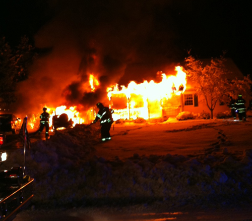 WADING RIVER FIRE DEPARTMENT COURTESY PHOTO | Firefighters combat the fire that destroyed the Dalecki family's home on Michael Lane.