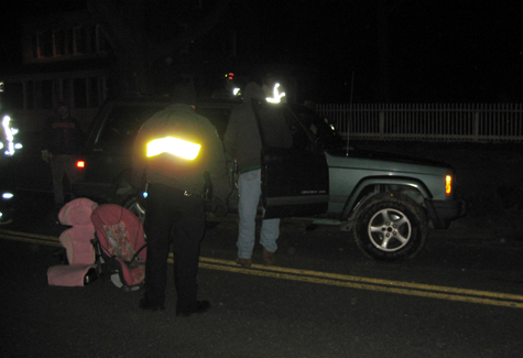 MICHAEL WHITE PHOTO | Police and firefighters after righting a Jeep Cherokee that had flipped onto its side in the westbound lanes of Sound Avenue near Martha Clara Vineyards.