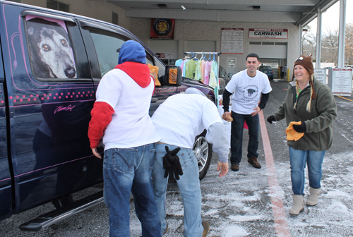 PAUL SQUIRE PHOTO | (L-R) Joel Neumann, Charles Puglisi and Joseph Luck of Absolute Detailing help clean a car with MTAS founder Denise Lucas Sunday morning.