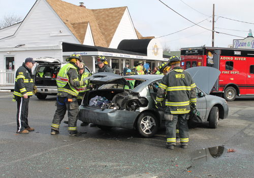 PAUL SQUIRE PHOTO | A woman was injured when she rolled out of this Saturn Ion after it was hit by a Jeep.