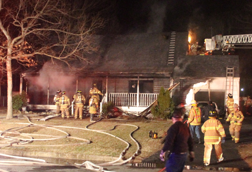 PAUL SQUIRE PHOTO | Riverhead firefighters battle a house fire early Monday morning.