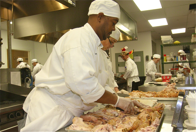 Jason Thomas of Riverhead carving up the roasted turkey, which he will also do on Thanksgiving for his family. (Credit: Barbaraellen Koch)
