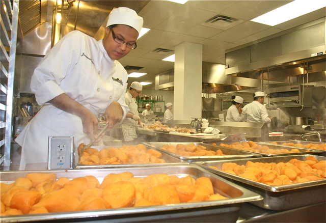 Jordan Gaines of Holbrook ladles out the 120 pounds of sweet potatoes. (Credit: Barbaraellen Koch)
