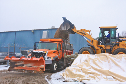 BARBARAELLEN KOCH PHOTO | Highway department assistant superintendent Mark Gajowski loads a truck up with sand/salt mixture at the highway department yard Thursday morning.
