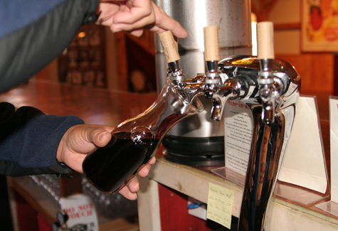 IMG_7667 JENNIFER GUSTAVSON PHOTO Juan Eduardo Micieli-Martinez, head winemaker and general manager at Martha Clara Vineyards in Riverhead, pours a red wine from its tap system, which features four different wines.