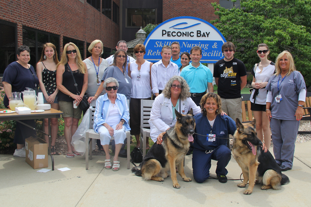 Sue Condreras of Northville (in navy) with PBMC officials during a memorial ceremony Thursday afternoon. (Credit: Carrie Miller)