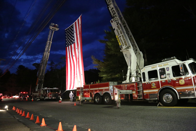 The American flag hangs outside the Wading River Fire Department Thursday night. (Photo Credit: Nicole Smith)