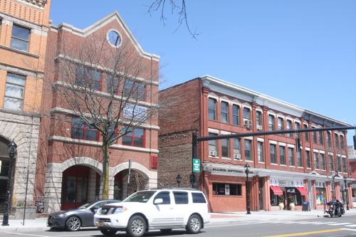 The owner of 30 West Main, pictured on the left, is hoping to bring in tenants next door where Allied Optical Plan currently does business. (Credit: Barbaraellen Koch)