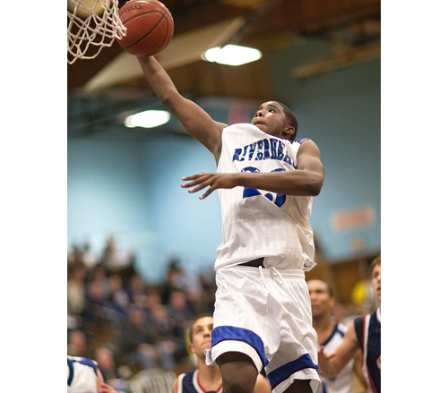 GARRET MEADE PHOTO | Riverhead senior Markim Austin rises for one-handed dunk Tuesday that put the Blue Waves ahead by seven in the fourth quarter against Smithtown West.