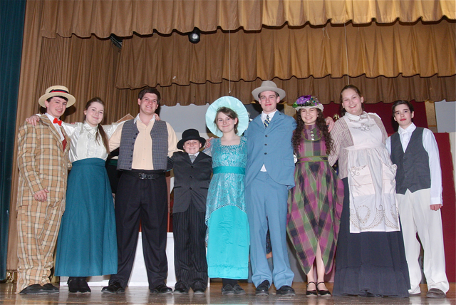 Cast members include (from left): Max Crean of Farmingdale as Harold Hill, Grace Lukachinski of South Jamesport as Marion Paroo, Cory Hermus of Bellport as Charlie Cowell, Joe Ryan of Riverhead as Mayor Shinn, Rebecca Lukachinski of South Jamesport as Eulalie Shinn, Chris Ryder of Moriches as Marcellus Washburn, Olivia Geppel of Mattituck as Ethel Toffelmier, Delia Kobel of Westhampton as Mrs. Paroo, Jason Crean of Farmingdale as Winthrop Paroo. (Credit: Barbaraellen Koch)