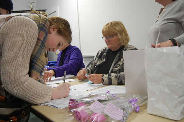 An attendee of Thursday night's Opioid Prevention Program signs up to receive a take home Narcan kit. (Credit: Nicole Smith)