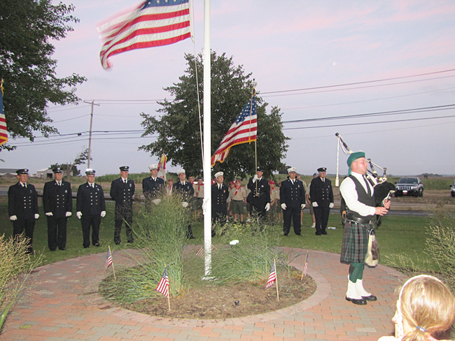 Patrick O'Neill plays the bagpipe during Thursday night's memorial at Reeves Park. (Credit: Tim Gannon)