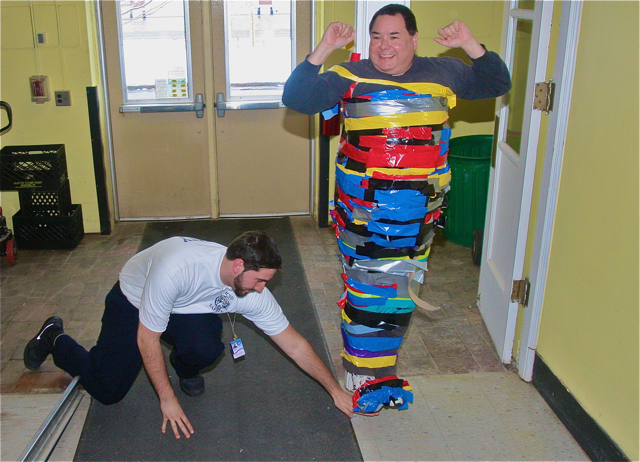 Security guard Chris Koerner checks the clearance below Mr. Payton's feet. Barbaraellen Koch photo