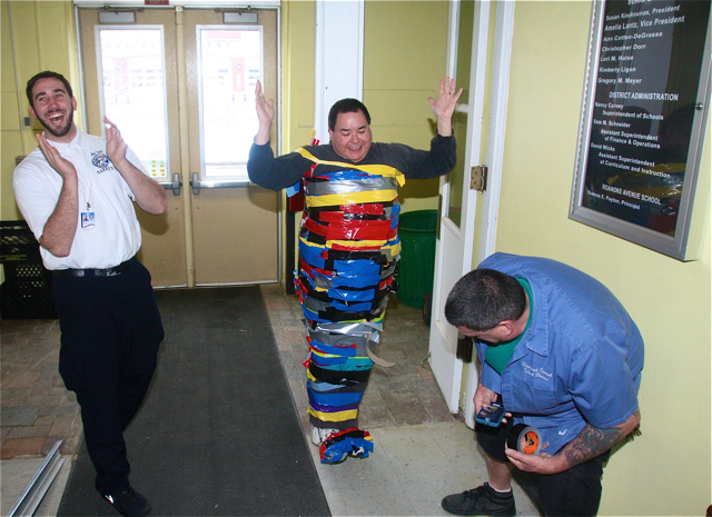 Security guard Chris Koerner gets a laugh and custodian Frank Sciarratta checks Mr.Payton's clearance off the ground. Barbaraellen Koch photo