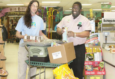 BARBARAELLEN KOCH PHOTO | Talmage Farm Agway showroom manager George Lemay (right) with animal care associate Dan Maeder of Animal Rescue Fund of the Hamptons Saturday.