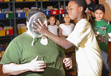 Pie3_BE_R.jpg BARBARAELLEN KOCH PHOTO Fourth grader Troyshaw Burgess throws the first pie in Principal Thomas Payton's face Friday.