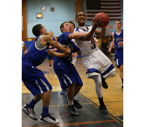 DANIEL DE MATO PHOTO | Riverhead senior Quinn Funn is hacked on the arm as he goes up for a shot Tuesday against Centereach. Funn scored 14 points in the victory.