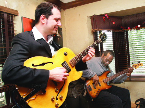 Guitarist and composer Nick Demopoulos (left) plays with bassist Paul Ramsey and drummer Jeremy Carlstedt (not pictured) in Baiting Hollow Farm Vineyard's tasting room Saturday afternoon as part of the Winterfest Jazz on the Vine series of musical performances benefiting East End Arts Council. Jazz on the Vine continues on weekends through March 20.
