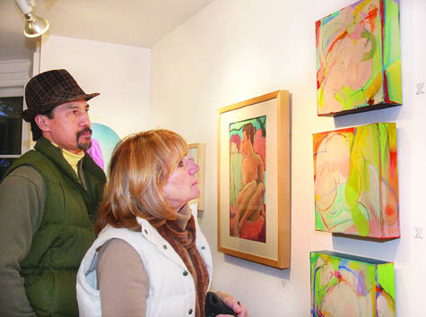 Denis Yuen and Karen Fellows of Aquebogue take a close look at the best in show acrylic paintings titled ‘M'lady 1, 2 and 3’ by Barbara Groot of East Hampton at the East End Arts Council gallery in Riverhead. Other winners in the juried show ‘Women: The Eternal Artist’s Muse and Inspiration’ that opened March 4 include Anne Seelbach of Sag Harbor, first place; Gena Griffiths of Cutchogue, second; and Gary Bartoloni of Greenport, third. The show runs through April 15.