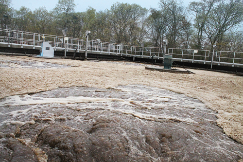 PAUL SQUIRE PHOTO | Waste water being aerated in one of the two 750,000-gallon treatment tanks at the Riverhead Sewer District plant. With the required plant upgrades, the treated water would be pumped through a high-tech filtration system.