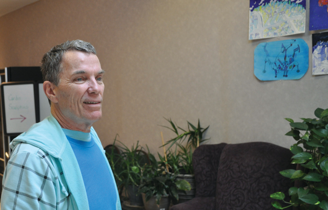 Robert Mince, 66, has his artwork on display in the hallway of the Riverhead Town Senior Center, where he spends a lot of his time during the week. (Credit: Joe Werkmeister)