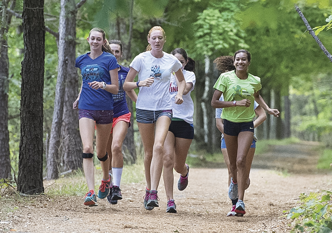 The Shoreham-Wading RIver girls cross country team, led by the trio of (from left) Kaitlyn Ohrtman, Alexandra Hays and Katherine Lee, will battle Miller Place and Bayport-Blue Point for the league and county titles. (Credit: Robert O'Rourk)