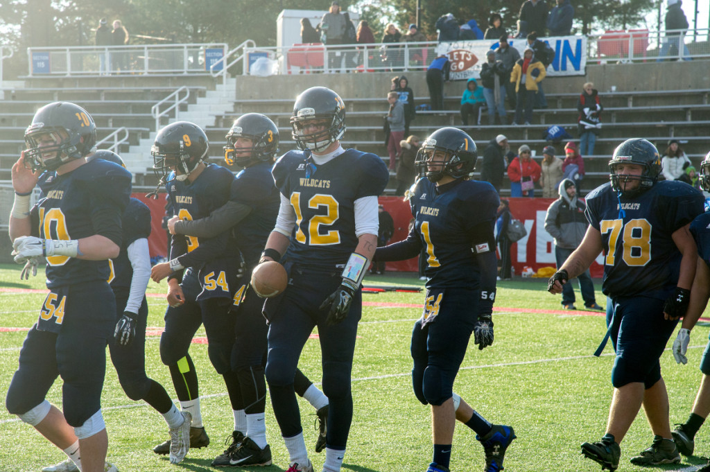 Shoreham-Wading River quarterback Danny Hughes (12) was all smiles after a Wildcats' touchdown against Glenn last week. (Credit: Robert O'Rourk)