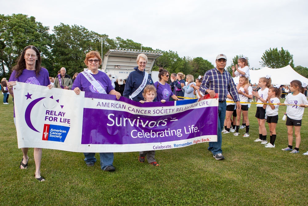Survivor Sam Duffy, center, leads the survivor walk. (Credit: Katharine Schroeder)