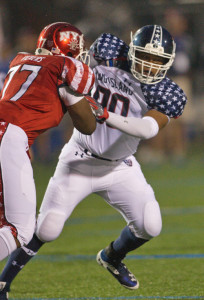 GARRET MEADE PHOTO | Riverhead's Nick Ross, fending off a block by New York City's Chad Vickers, played defensive end for the first time in two years.