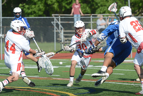 ROBERT O'ROURK PHOTO | Riverhead's airborne Keith Jefferson firing a point-blank shot that is saved by Smithtown East's Brian Balkam.