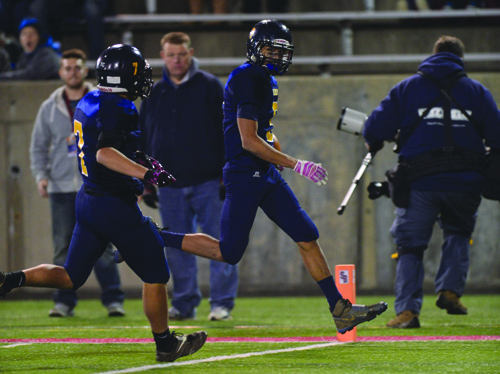 Isreal Squires, with an escort provided by Bryce Casey, crossing the goal line for an 80-yard touchdown reception. (Credit: Robert O'Rourk)