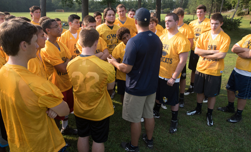 Shoreham-Wading River coach Matt Millheiser addressing his players following a water break. (Credit: Robert O'Rourk)