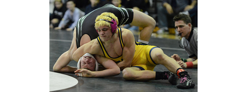 ROBERT O'ROURK PHOTO | Shoreham-Wading River's T. J. Fabian has Westhampton Beach's Nick Strand in an awkward position before pinning him 26 seconds into the 126-pound final. Fabian became the fifth Shoreham-Wading River wrestler to win four league titles, according to Wildcats coach Joe Condon.