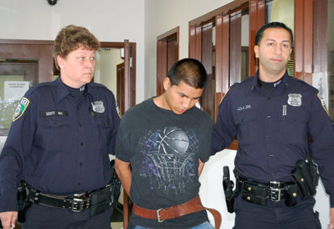 Soyos-Pixtun VERA CHINESE FILE PHOTO | Two Riverhead Town police officers lead Juan Soyos-Pixtun to town Justice Court after his arrest in November.