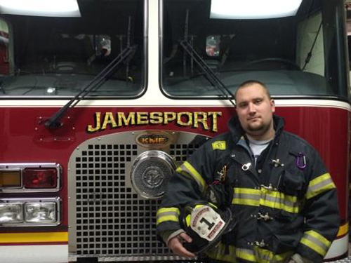 Lt. Stevie Czelatka Jr. in front of a Jamesport fire engine. (Courtesy file photo)